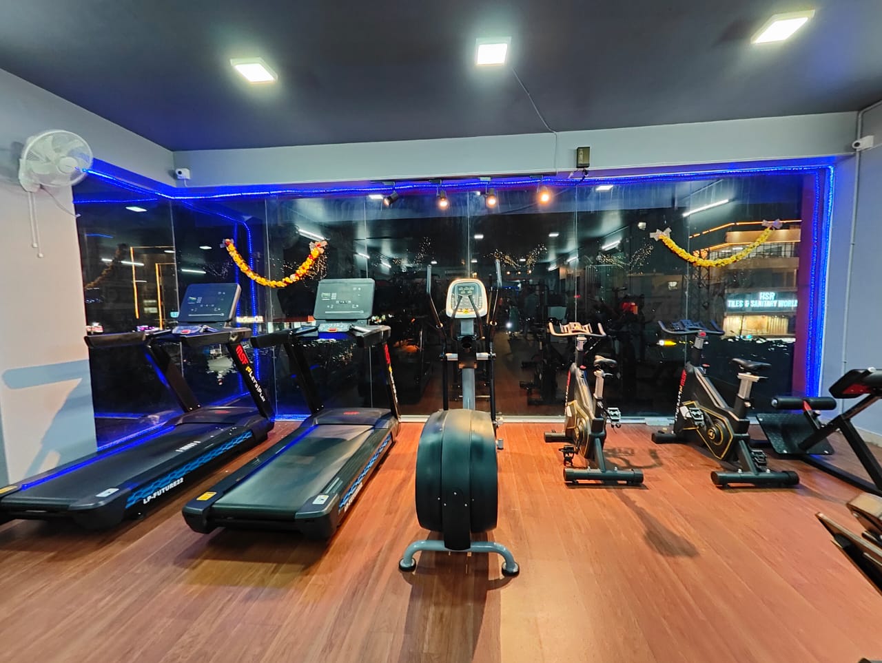 Cardio zone at Fit Station Gym with treadmills, elliptical cross-trainer and spin bikes
