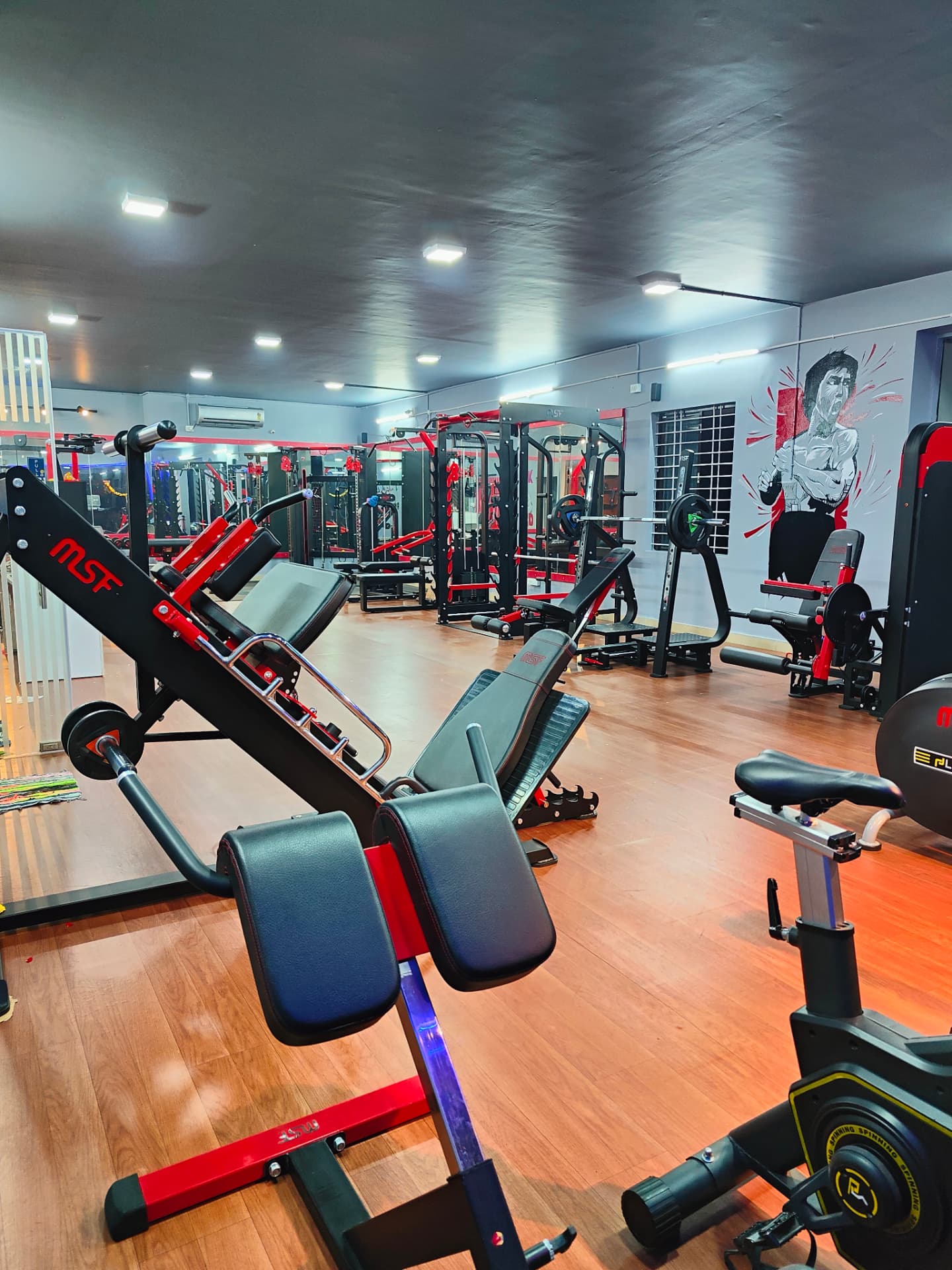 Fit Station Gym strength training floor with MSF leg press, squat racks and benches in HSR Layout, Bengaluru